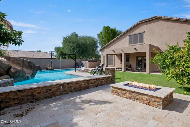 a view of backyard with swimming pool