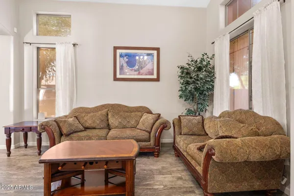 a living room with furniture a couch and a potted plant
