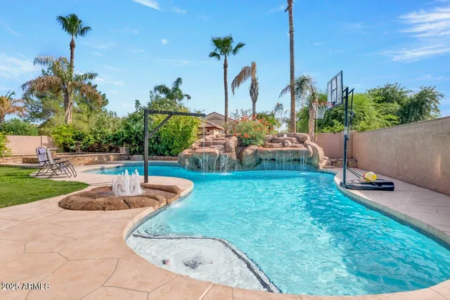 a view of backyard with outdoor seating and plants