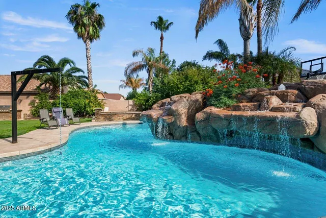 a view of a house with pool and garden