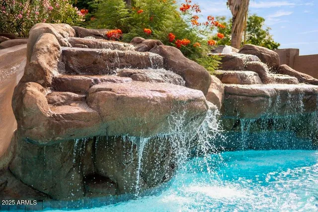 a view of a patio with table and chairs under an umbrella