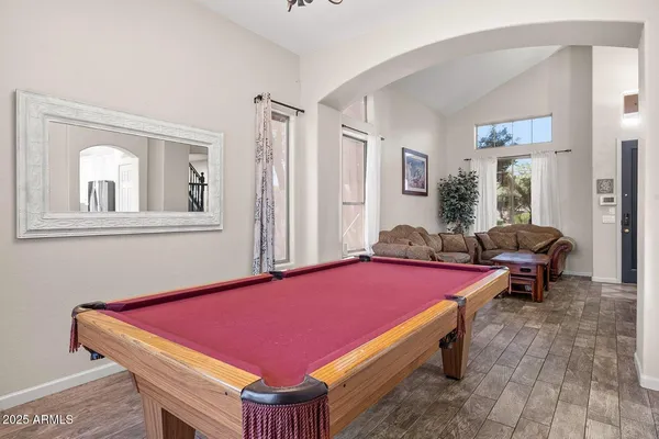 a room with pool table and windows