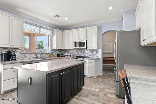 a kitchen with a appliances and cabinets