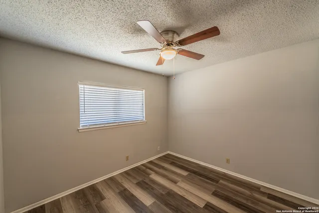 a view of room with window and ceiling fan