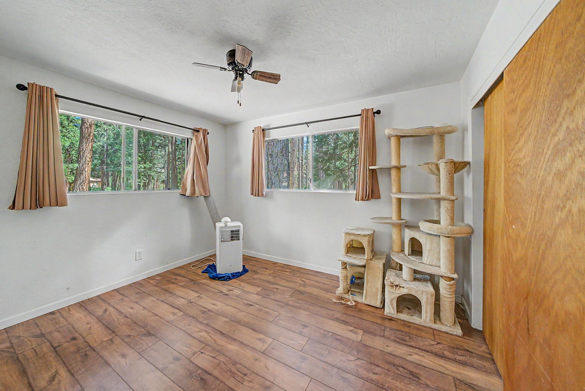 58374 Gill Ranch Road Cromberg, CA 96103 - Photo 29 of 44 a living room with wooden floor and a window