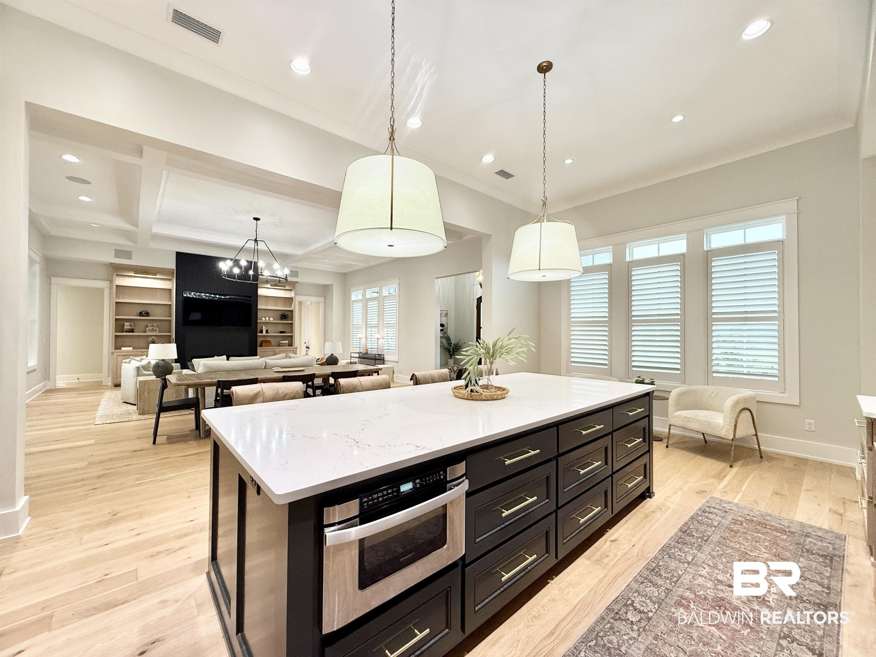 21767 Gallery Boulevard Fairhope, AL 36532 - Photo 15 of 74 Kitchen with recessed lighting, pendant lighting, light wood finished floors, beam ceiling, and a kitchen island