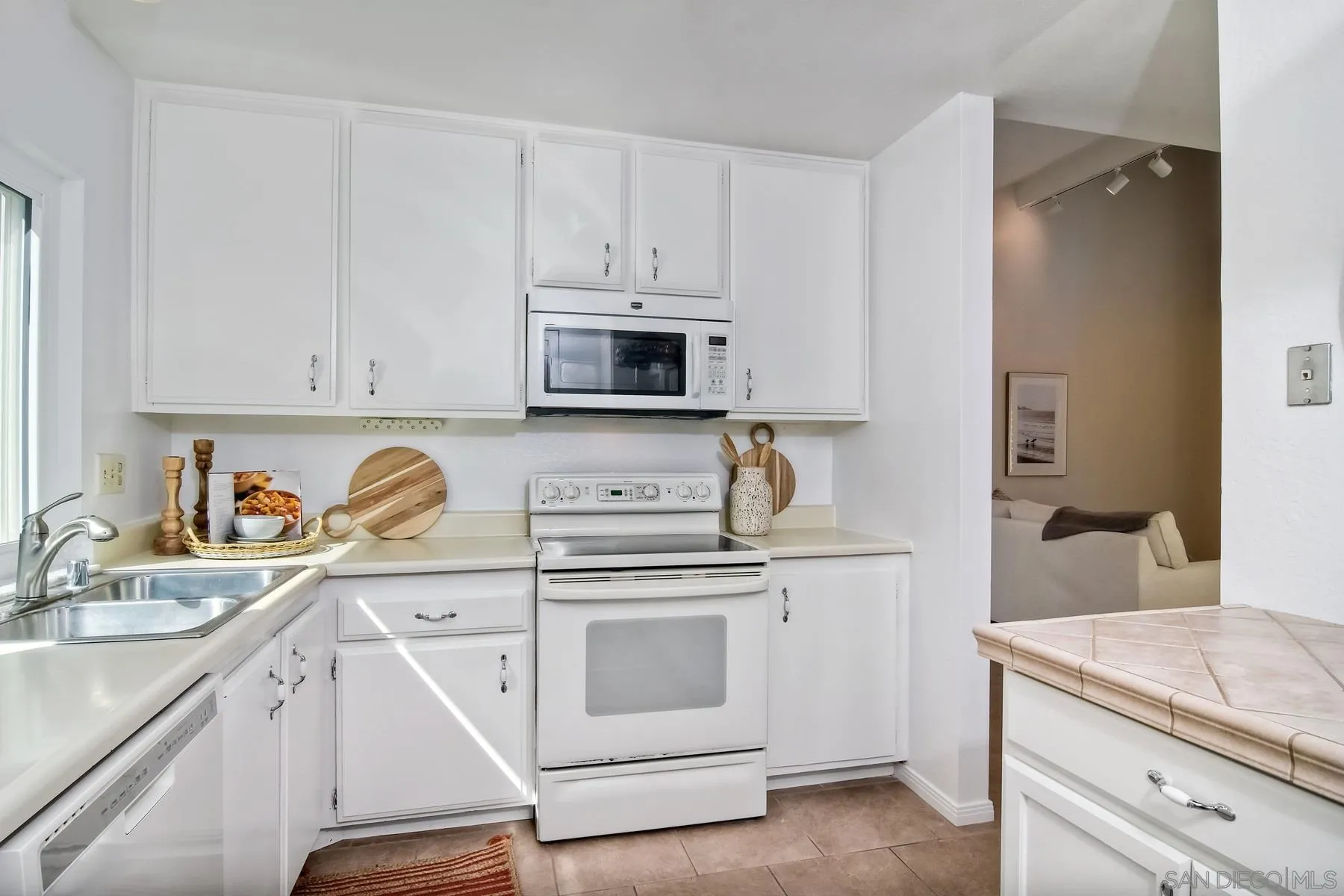 803 Caminito Azul Carlsbad, CA 92011 - Photo 13 of 41 a kitchen with granite countertop white cabinets and white appliances