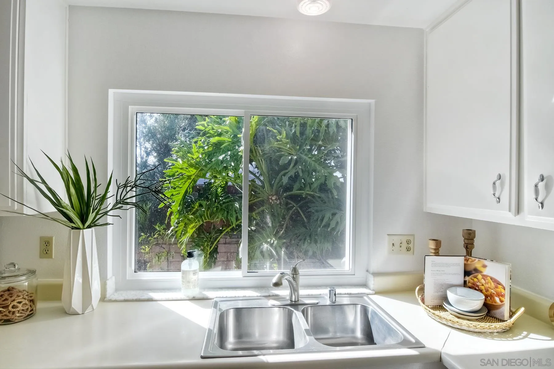 803 Caminito Azul Carlsbad, CA 92011 - Photo 14 of 41 a kitchen with a sink and a large window
