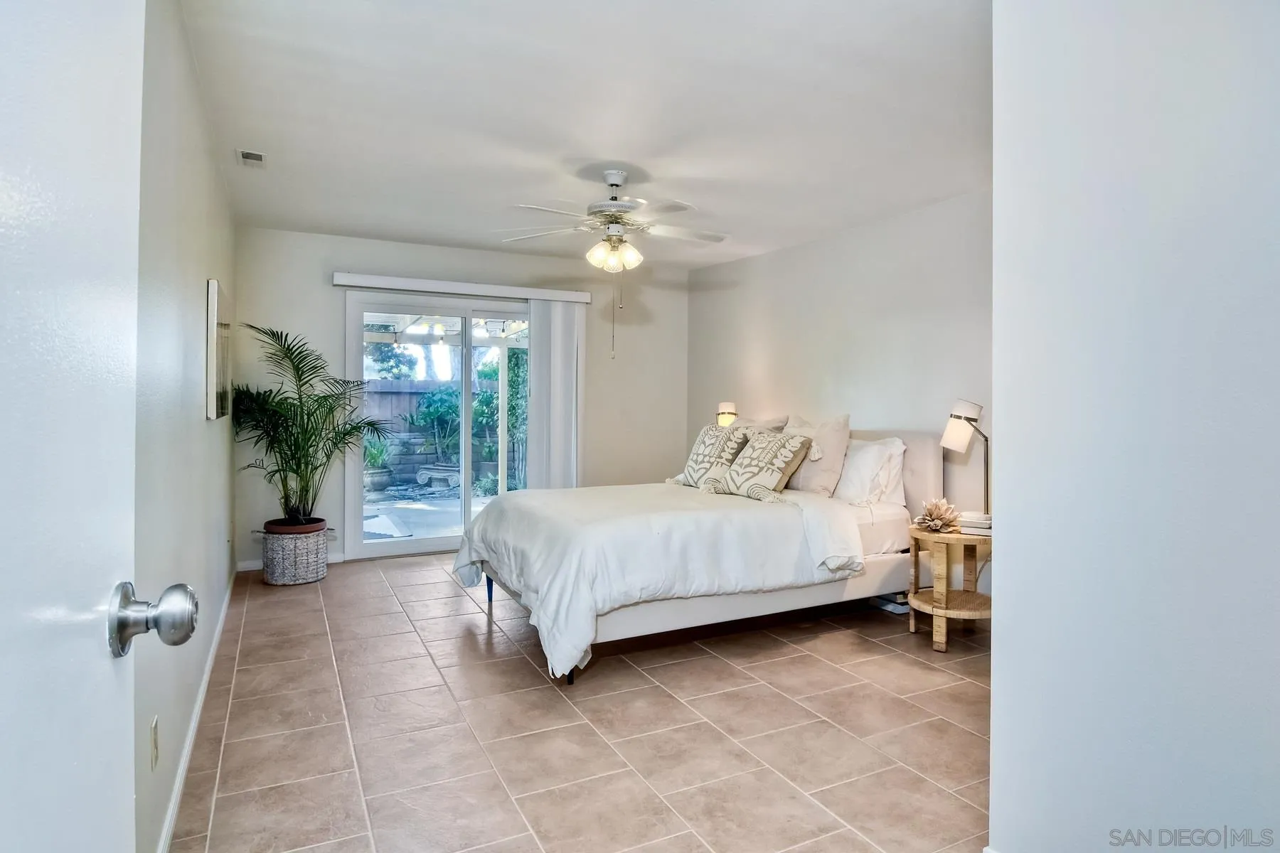 803 Caminito Azul Carlsbad, CA 92011 - Photo 20 of 41 a bedroom with a bed and a chandelier