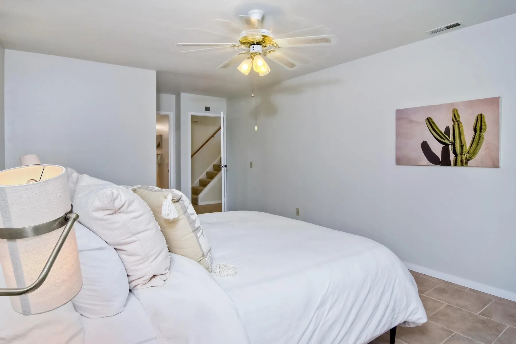 803 Caminito Azul Carlsbad, CA 92011 - Photo 23 of 41 a bedroom with a bed and a chandelier