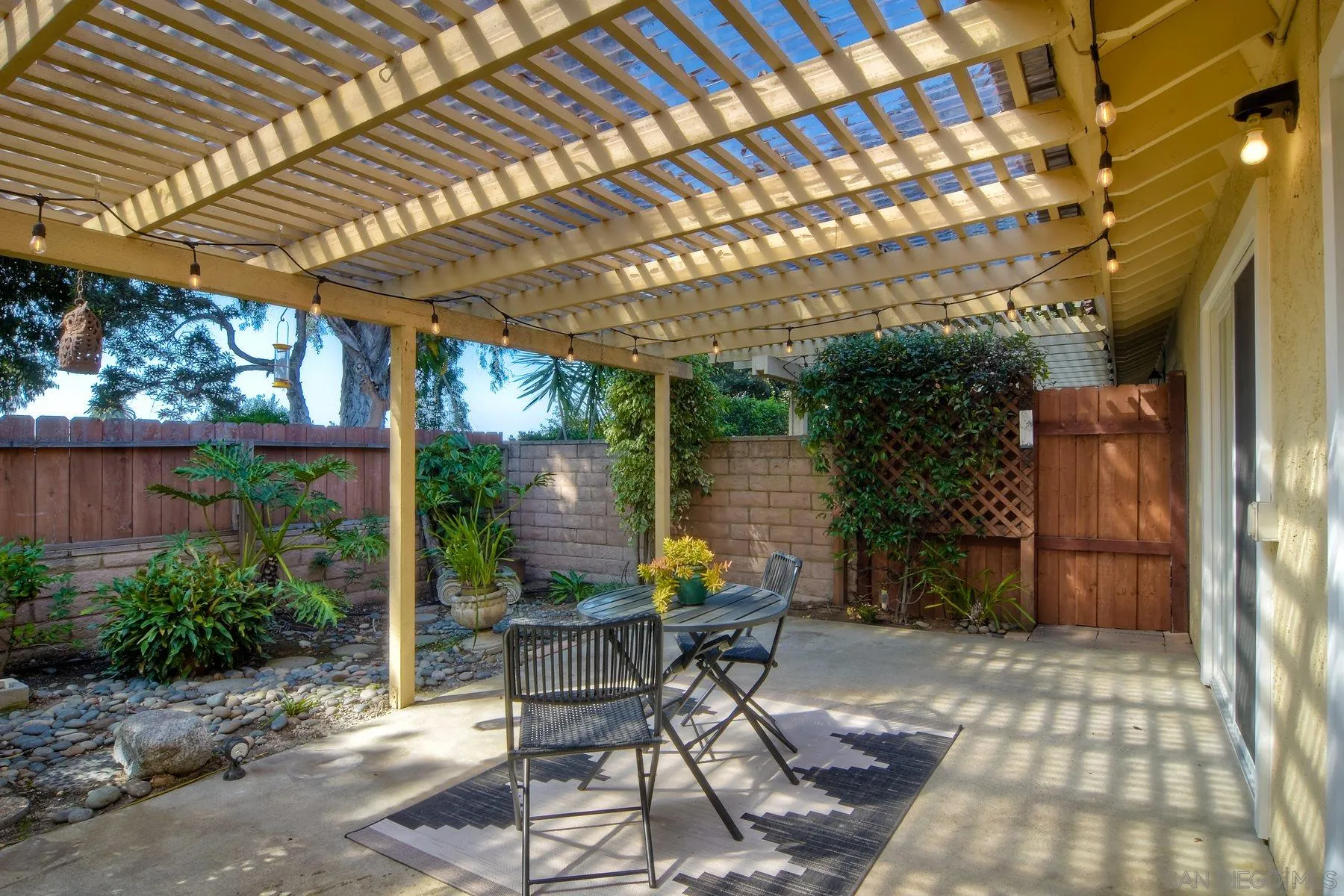 803 Caminito Azul Carlsbad, CA 92011 - Photo 32 of 41 a patio with table and chairs and potted plants