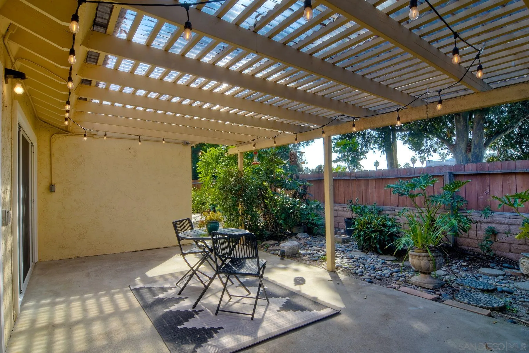 803 Caminito Azul Carlsbad, CA 92011 - Photo 33 of 41 a patio with table and chairs and potted plants