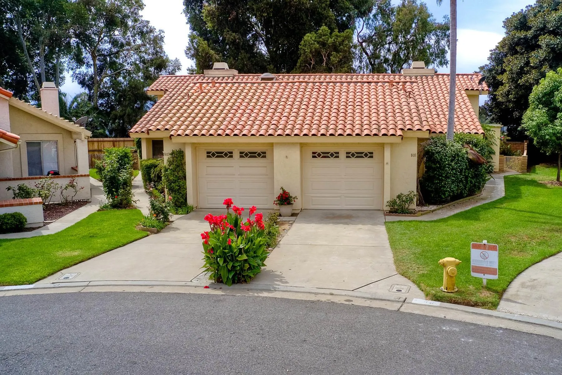 803 Caminito Azul Carlsbad, CA 92011 - Photo 37 of 41 a front view of a house with a garden and trees
