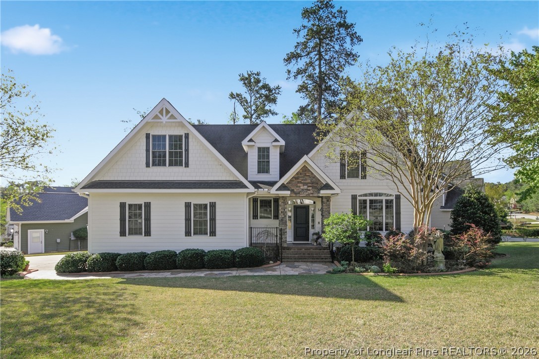 14 Spring Water Court Spring Lake, NC 28390 - Photo 34 of 34 a front view of a house with a garden and trees