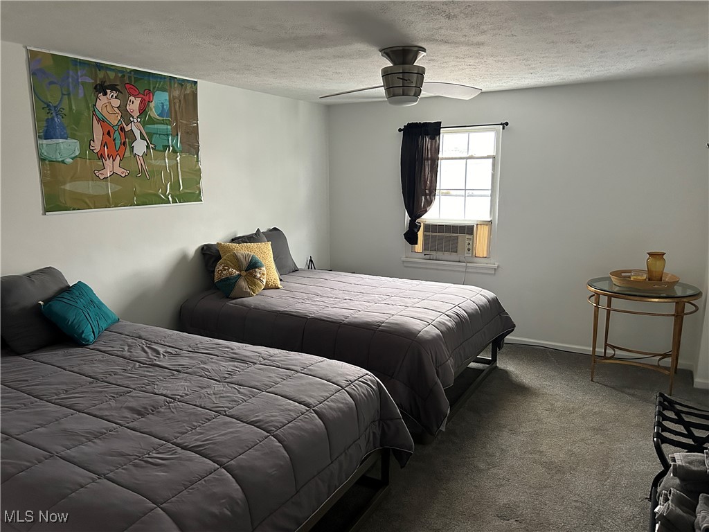 3005 Bardshar Road Sandusky, OH 44870 - Photo 14 of 24 Carpeted bedroom with ceiling fan, cooling unit, baseboards, and a textured ceiling