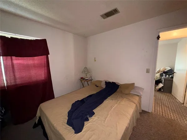a bedroom with a bed and a mirror