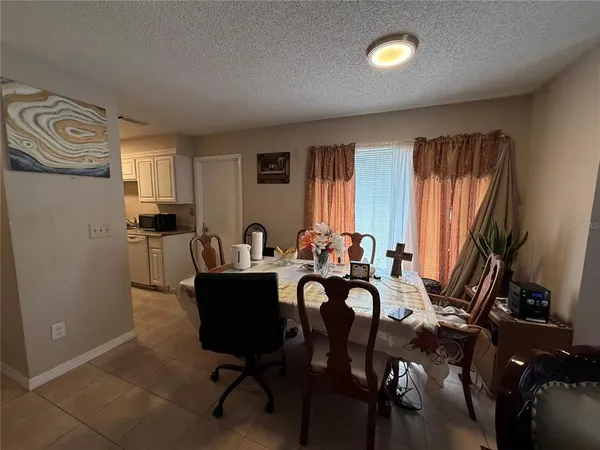 a view of a dining room with furniture and a window