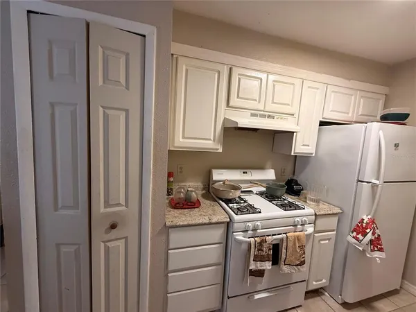 a kitchen with stainless steel appliances granite countertop a refrigerator sink and cabinets