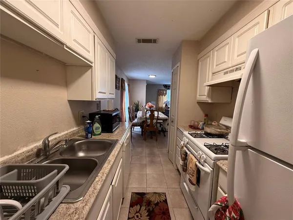 a kitchen with a sink appliances and a window