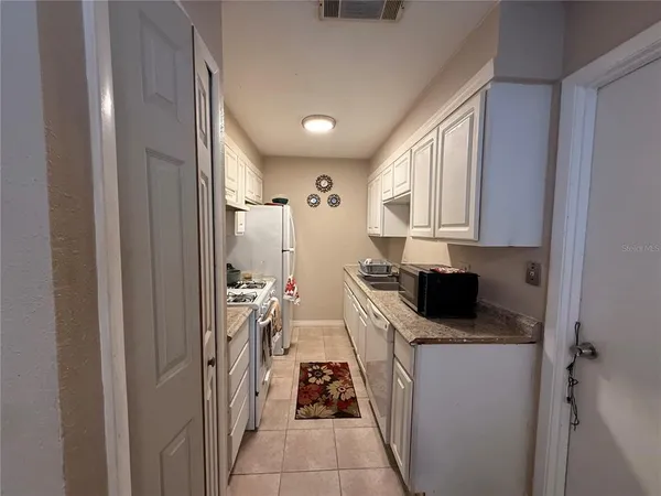 a kitchen with a stove and a refrigerator