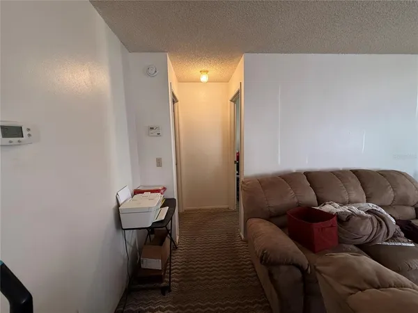 a living room with furniture and a mirror