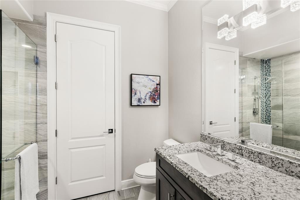11255 Macaw Court Windermere, FL 34786 - Photo 15 of 49 a bathroom with a granite countertop sink a toilet and a mirror