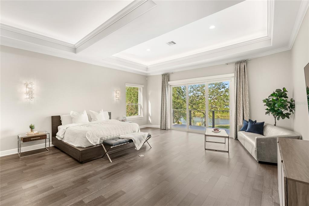 11255 Macaw Court Windermere, FL 34786 - Photo 20 of 49 a spacious bedroom with a bed and a couch