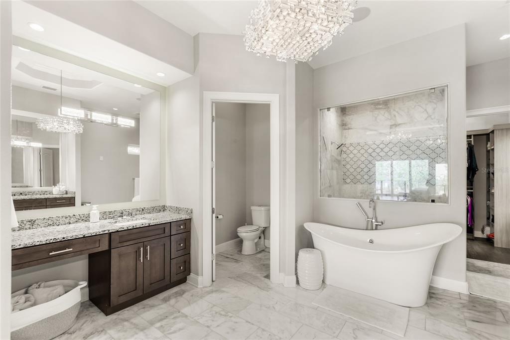 11255 Macaw Court Windermere, FL 34786 - Photo 23 of 49 a spacious bathroom with a double vanity sink mirror and bathtub