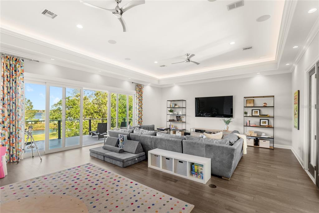 11255 Macaw Court Windermere, FL 34786 - Photo 28 of 49 a living room with furniture and a flat screen tv