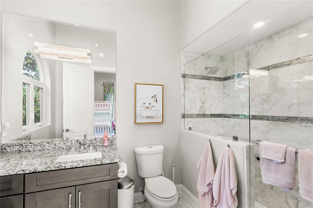 11255 Macaw Court Windermere, FL 34786 - Photo 33 of 49 a bathroom with a sink toilet vanity and shower