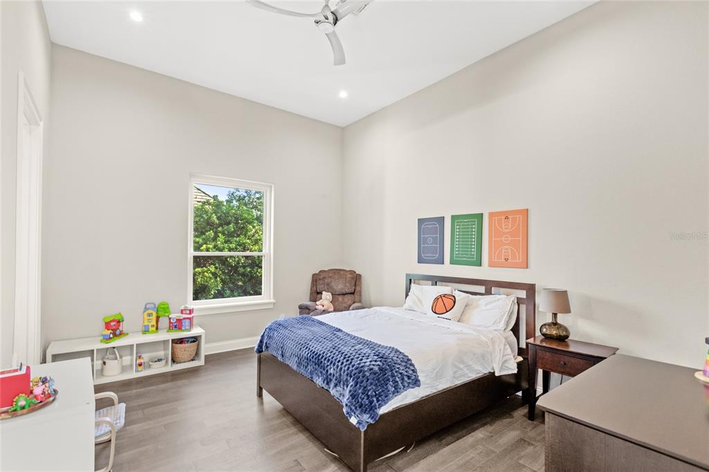 11255 Macaw Court Windermere, FL 34786 - Photo 34 of 49 a bedroom with a bed and a window