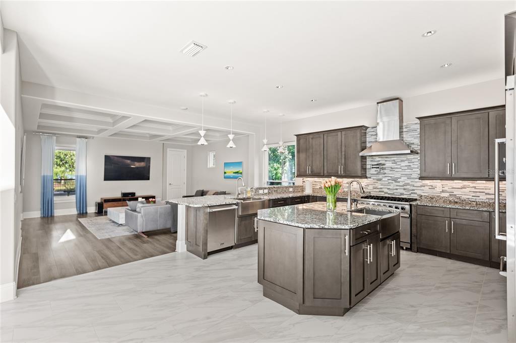 11255 Macaw Court Windermere, FL 34786 - Photo 10 of 49 a kitchen with stainless steel appliances granite countertop a sink stove and refrigerator