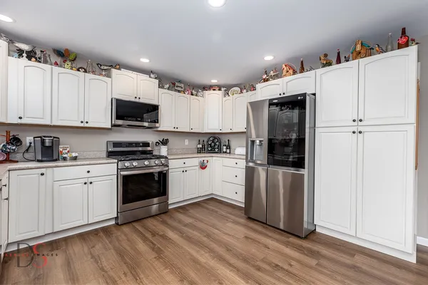 a kitchen with stainless steel appliances a refrigerator stove and microwave
