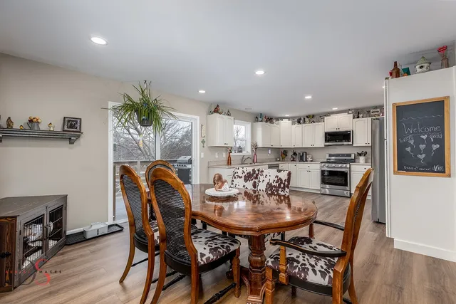 a view of a dining room with furniture and wooden floor