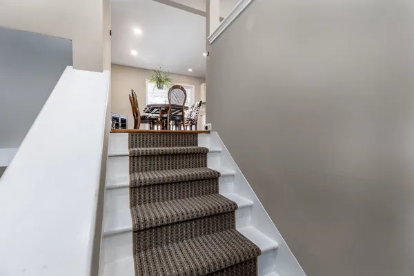 a kitchen with granite countertop white cabinets and stainless steel appliances