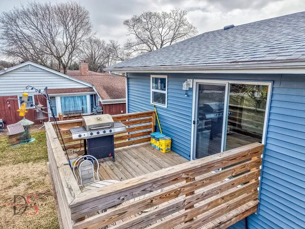 a view of backyard with seating space and wooden fence