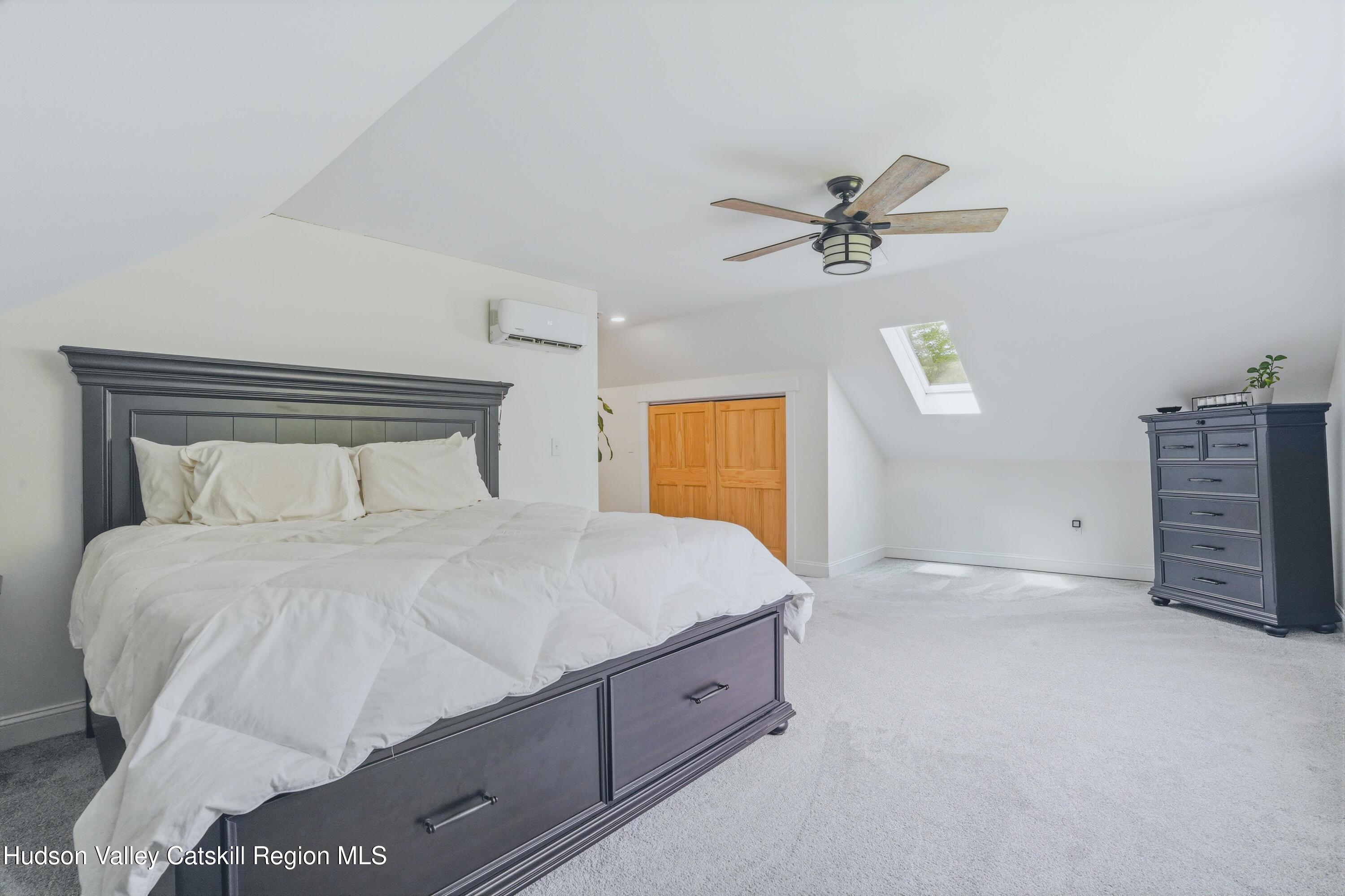 757 Taborton Road Sand Lake, NY 12153 - Photo 20 of 32 a spacious bedroom with a bed and a chandelier