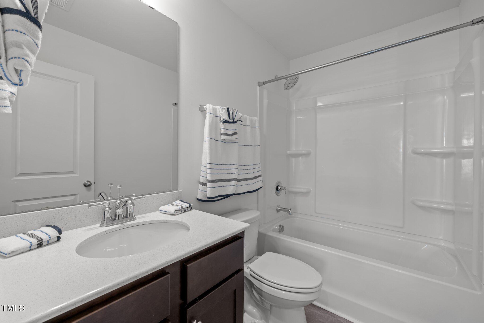3120 Crater Loop Raleigh, NC 27610 - Photo 13 of 19 a bathroom with a sink toilet tub vanity and shower