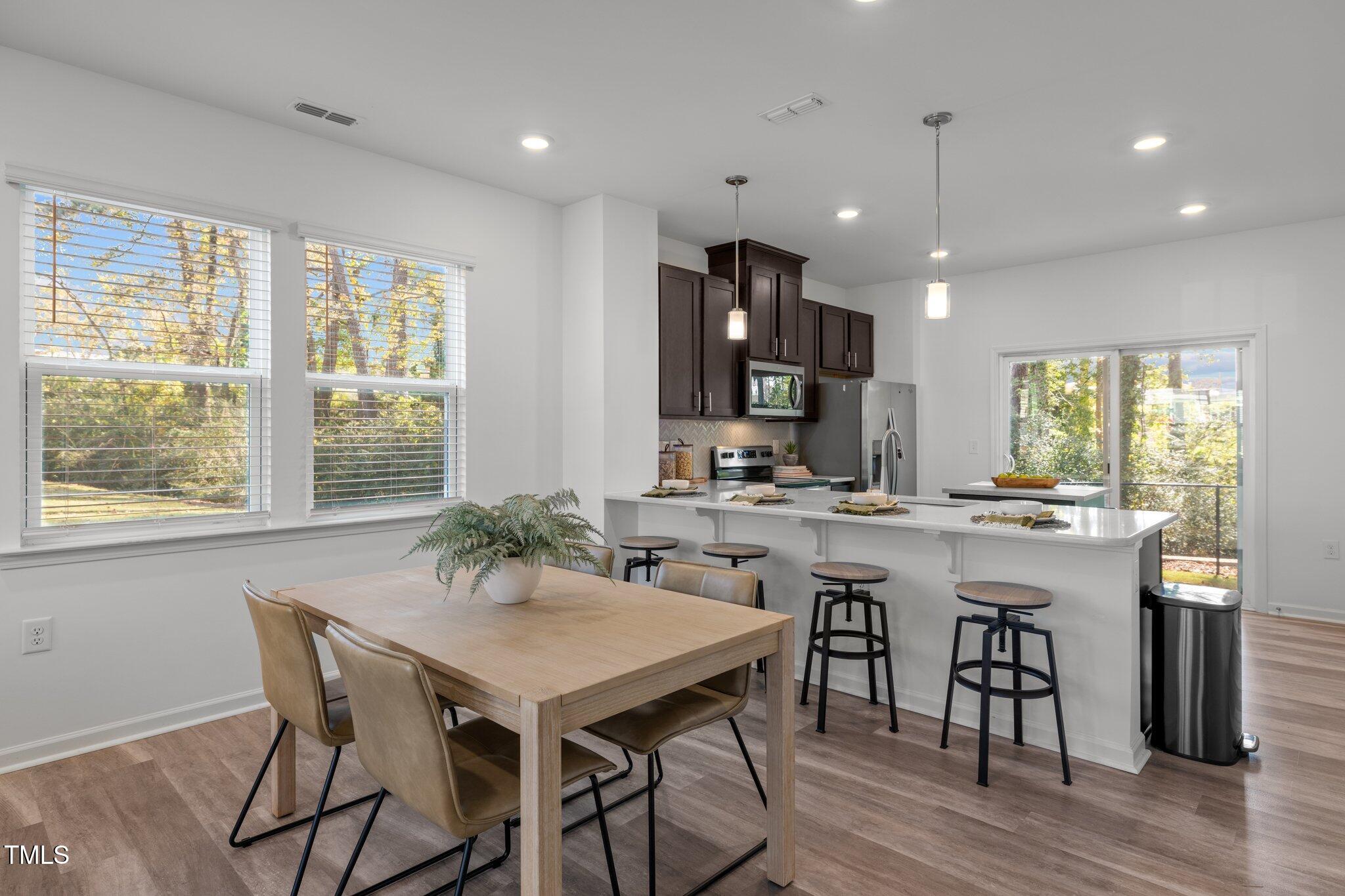 3120 Crater Loop Raleigh, NC 27610 - Photo 6 of 19 a kitchen with a table and chairs in it