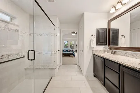 a bathroom with a double vanity sink and mirror