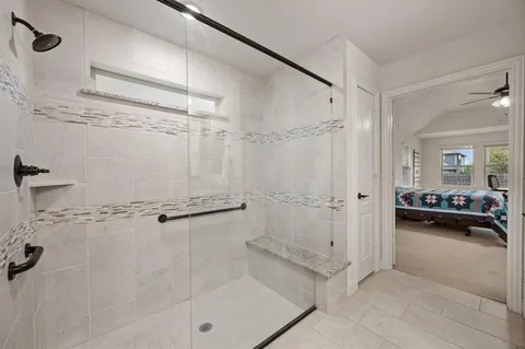 a bathroom with a shower and a tub
