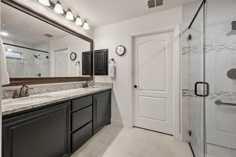 a bathroom with a double vanity sink and mirror