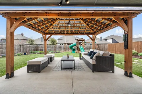 a roof deck with couch and chairs