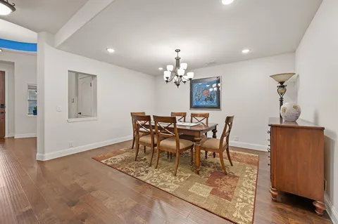 a dining room with furniture and chandelier