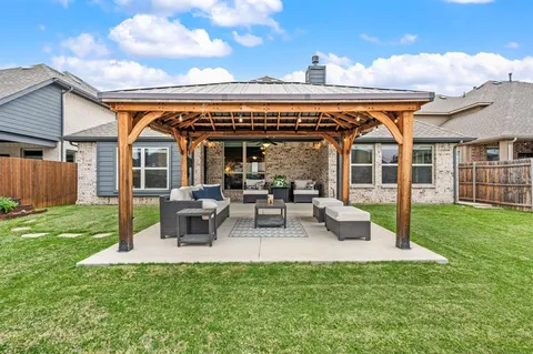 a view of a house with backyard porch and sitting area