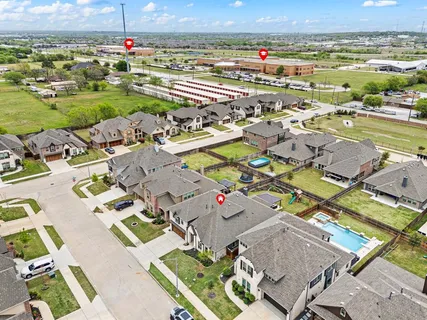 an aerial view of a city with lots of residential buildings and mountain view in back