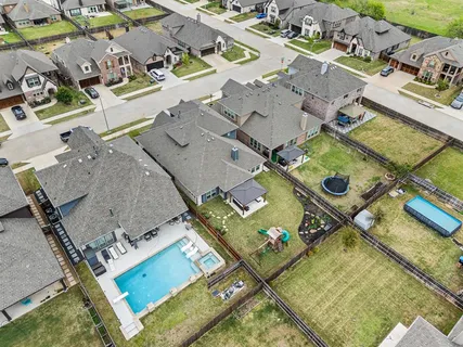 an aerial view of a house with a swimming pool
