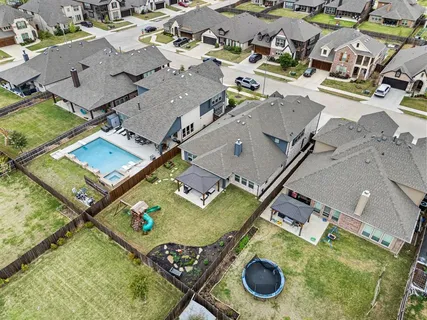 an aerial view of residential houses with outdoor space