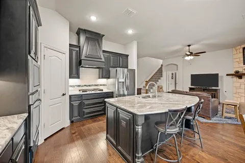 a large kitchen with a table and chairs