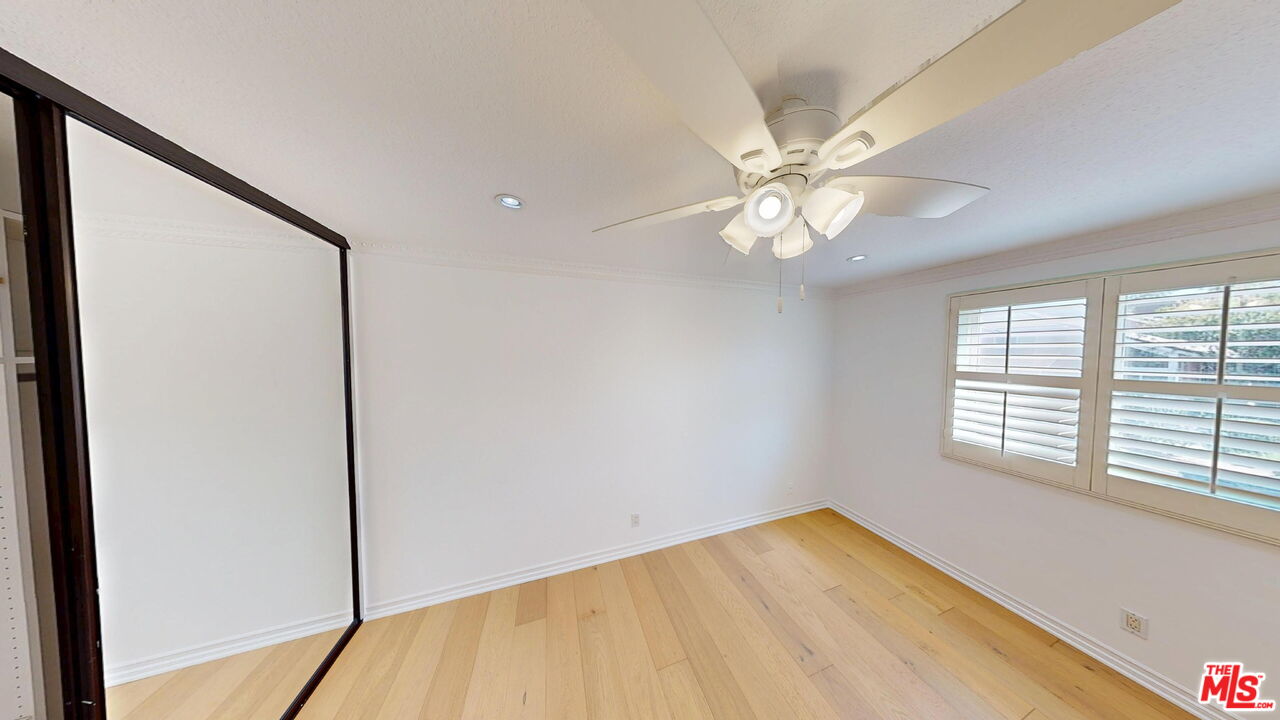 19219 Dunure Place Porter Ranch, CA 91326 - Photo 18 of 30 a view of an empty room with windows and chandelier fan